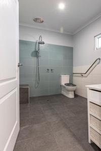 a bathroom with a shower and a toilet at Topp House Retreat in Bethany