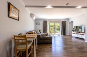 a living room with a table and a couch at Topp House Retreat in Bethany