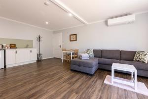 a living room with a couch and a table at Topp House Retreat in Bethany +7 photos
