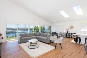 a living room with a couch and a table at 2 Ulmarra in Manning Point