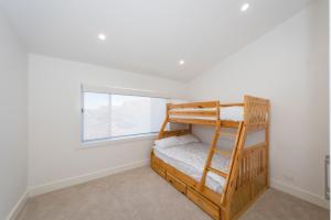 a bedroom with a bunk bed and a window at 2 Ulmarra in Manning Point