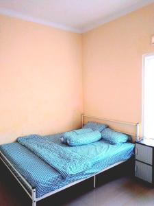 a bed in a room with two pillows on it at Locita Villa in Batu