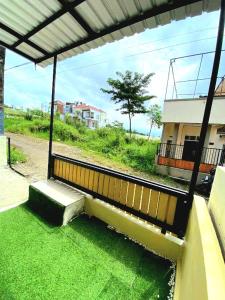 a bench sitting on top of green grass at Locita Villa in Batu