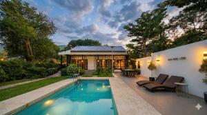 a house with a swimming pool in the backyard at Ban Rub Lom Pool Villa 3 difference villas in Rayong