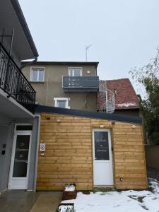 a wooden building with two doors and a balcony at Le Panoramique in Saint-Parize-le-Châtel