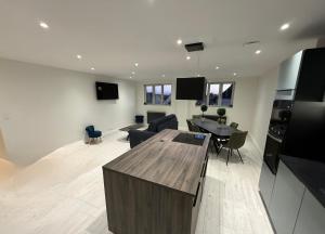 a living room with a kitchen and a dining room at Le Panoramique in Saint-Parize-le-Châtel