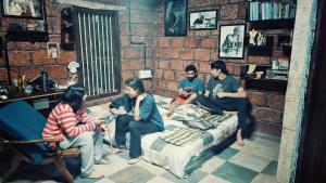 a group of people sitting in a room at Vyugen Villa #01 in Kāraikkudi