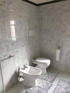 a bathroom with a toilet and a sink at Sarina House Ocean View in Lavagna