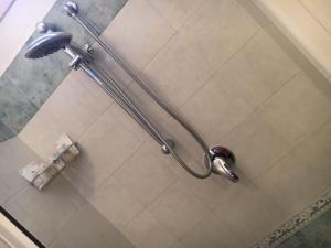 a shower in a bathroom with a shower head at Casa Del Sole B&B in Tropea