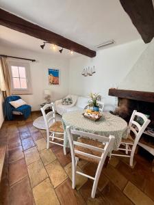 a living room with a table and chairs and a couch at Maison coeur de village Ramatuelle in Ramatuelle