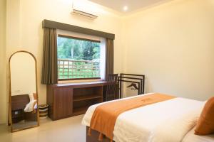 a bedroom with a bed and a window with a balcony at Semu Villa - Three Bedroom Private Pool Villa in Pawenang +50 photos