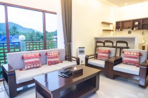 a living room with two couches and a fireplace at Semu Villa - Three Bedroom Private Pool Villa in Pawenang