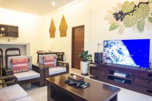 a living room with a large flat screen tv at Semu Villa - Three Bedroom Private Pool Villa in Pawenang