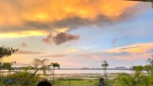 a view of a beach with a cloudy sky at Lapwing Lake Villa in Tissamaharama