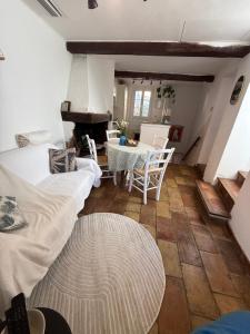 a room with two beds and a table and a table and chairs at Maison coeur de village Ramatuelle in Ramatuelle +16 photos
