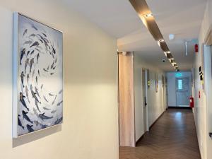 a hallway with a painting on the wall at Indigo Hotel Hatyai 2 Khet 8 in Sathani Hat Yai