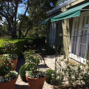 um jardim em frente a uma casa com vasos de plantas em Passagem da Neblina - Bed & Breakfast em Campos de Jordão