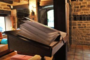 a box with a stack of papers in a room with a fireplace at Agroturismo el Encuentro in Leza