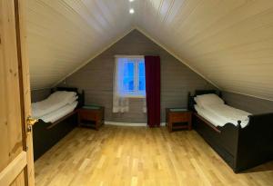 a room with two beds and a window at The house in Vika in Lødingen