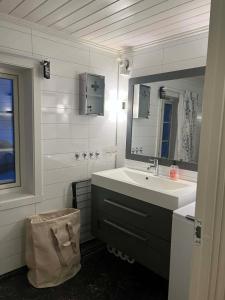 a bathroom with a sink and a mirror at The house in Vika in Lødingen