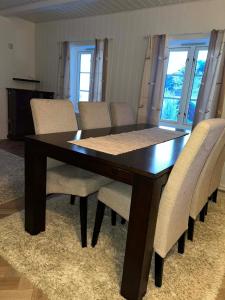 a dining room table with chairs and a wooden table at The house in Vika in Lødingen +39 photos