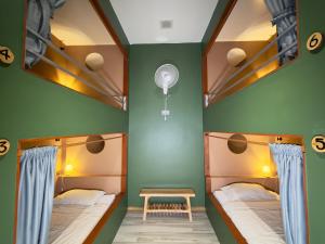 two bunk beds in a room with green walls at Beach Jungle in Ko Chang