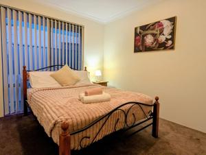 a bed in a room with a window and a bed sidx sidx sidx at Grand stay in Perth +11 photos