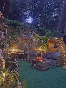 a patio with couches and a table and lights at petit cocon in Toulon
