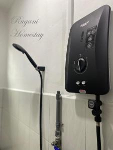a hair dryer is attached to a wall at Rugani Homestay in Papar