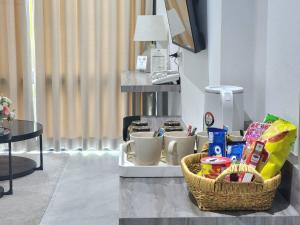 a basket of food and drinks on a table at Tree Airport Hotel Hatyai in Hat Yai Intl
