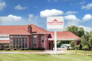 a hampton inn sign in front of a building at Hawthorn Suites Irving DFW South in Irving