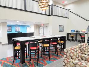 a large dining room with a table and chairs at Hawthorn Suites Irving DFW South in Irving
