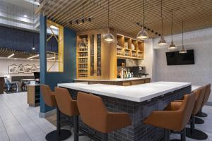 a bar in a restaurant with chairs and lights at Hyatt Place Austin The Domain Area in Austin