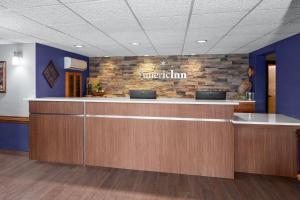 a lobby of a hospital with a reception counter at AmericInn by Wyndham Green Bay West in Green Bay +46 photos