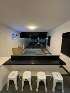 a room with two tables and two stools in a building at Tatz Pool Villa in Anunas +3 photos