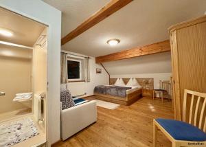a bedroom with a bed and a living room at Bio-Bauernhof Simonbauer in Ramsau am Dachstein +123 photos