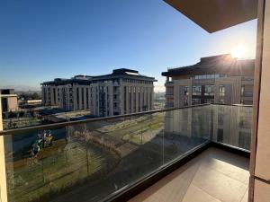 a balcony with a view of a city with buildings at Surxondaryo Hotel Tashkent in Teshabayguzar
