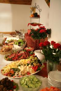 a buffet of food on a table with plates of food at Nassauer Hof in Sankt Goarshausen