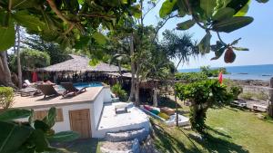 a resort with a pool and chairs and the ocean at Coco Tent Seaview 360 in Ko Lanta