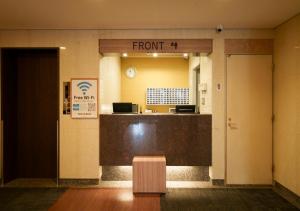 an empty lobby with a front desk in a building at Smile Hotel Tokyo Asagaya in Tokyo