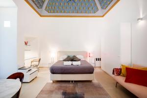 a bedroom with a bed and a couch at Dimora Delle Stelle - Design & Heritage in Bari