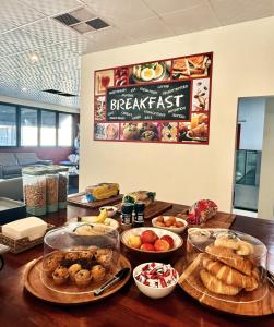 a table with many different types of food on it at Gallery Boutique Hotel in Fremantle
