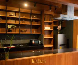 a kitchen with wooden cabinets and a counter top at Lualhati Homestay in Baguio +20 photos