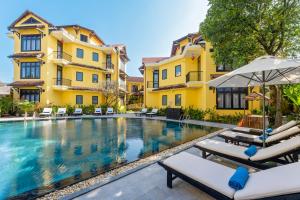 an image of a swimming pool in front of a building at Lantern Boutique Hoi An in Hoi An