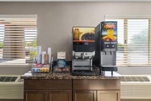 a coffee machine sitting on top of a counter at Super 8 by Wyndham Casa Grande in Casa Grande