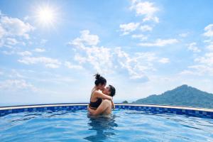 a woman sitting in a swimming pool at Sun Villa Tam Đảo in Vĩnh Phúc
