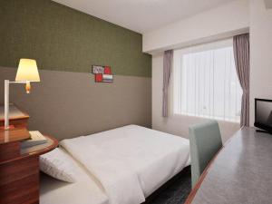 a hotel room with a bed and a window at Comfort Hotel Toyokawa in Toyokawa +36 photos