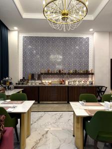 a restaurant with tables and chairs and a bar at Surxondaryo Hotel Tashkent in Teshabayguzar