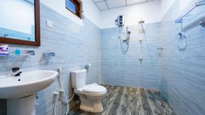a bathroom with a toilet and a sink and a shower at Nimsara Lodge Sigiriya in Sigiriya +88 photos