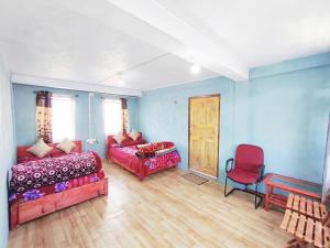 a room with a bed and a couch and a chair at Betzer homestay in Cherrapunji +12 photos